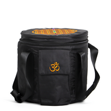 Load image into Gallery viewer, This is a cylindrical carrying case specifically designed for crystal singing bowls, made from black fabric. The front of the bag features an orange embroidered "ॐ" (Om) symbol. The top is decorated with the Flower of Life and the seven chakras, symbolizing the structure of the universe and the body's energy centers. The bag includes a zipper and a shoulder strap for easy carrying, effectively protecting the crystal singing bowl during transport.